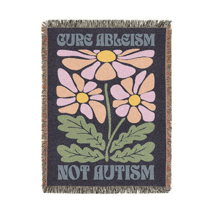 Blanket with floral design and text 'Cure Ableism Not Autism' on a white background